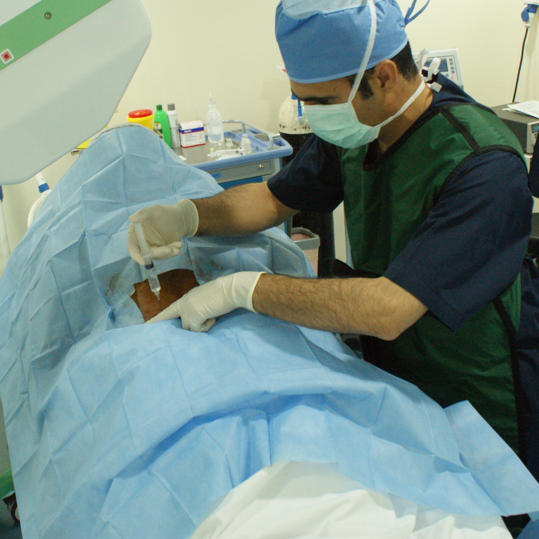 Dr. Yousif Sharaf administering a Transforaminal Nerve Block injection to relieve pain and enhance the patient’s quality of life